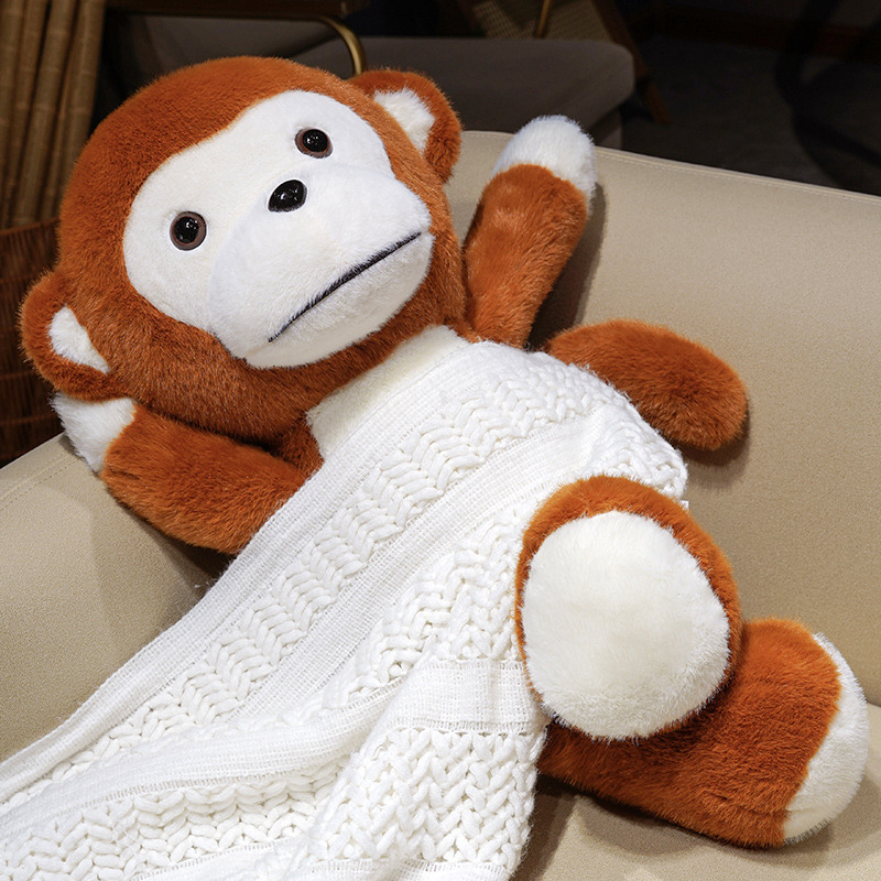 Cute Monkey Plush Toy resting on a sofa with a knitted blanket, featuring soft plush fabric and a cuddly monkey design
