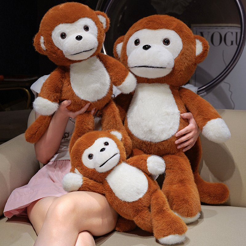 Cute Monkey Plush Toys in multiple sizes displayed together on a sofa, featuring soft plush fabric and playful swinging limbs