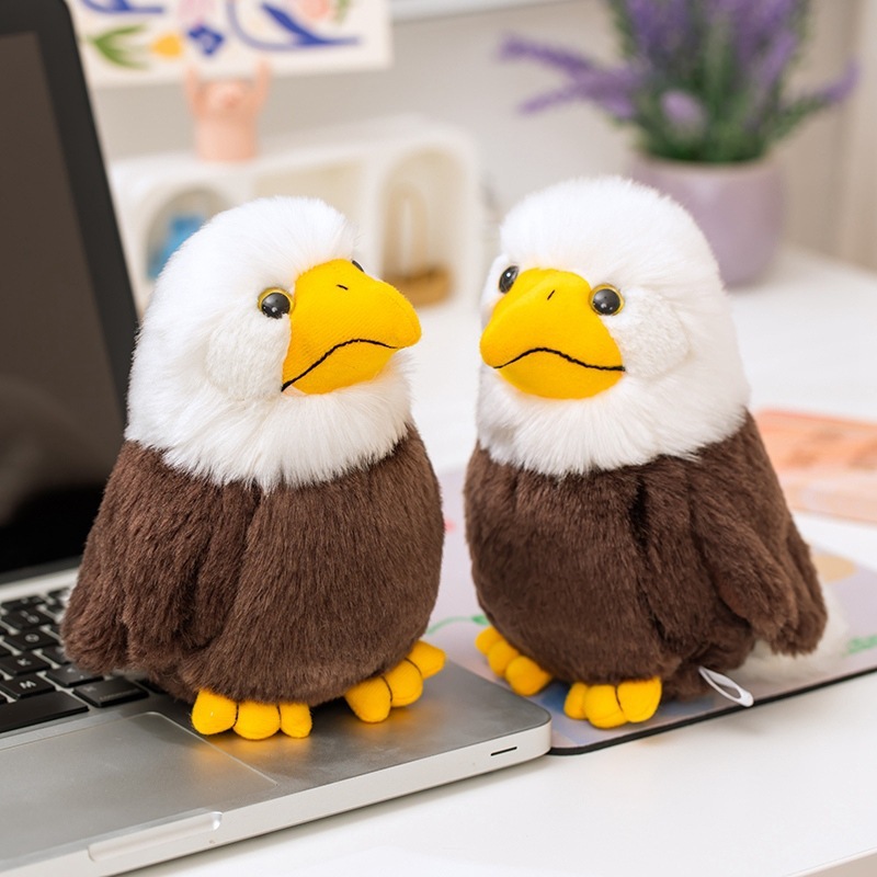 Two Bald Eagle Plush Toys displayed on a desk, showcasing realistic eagle-inspired features and soft plush textures