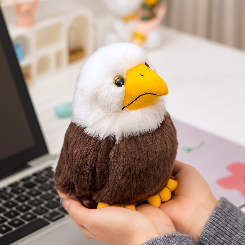 Bald Eagle Plush Toy held in hand, featuring fluffy white feathers, a bright yellow beak, soft plush fabric, and a compact wildlife-inspired design