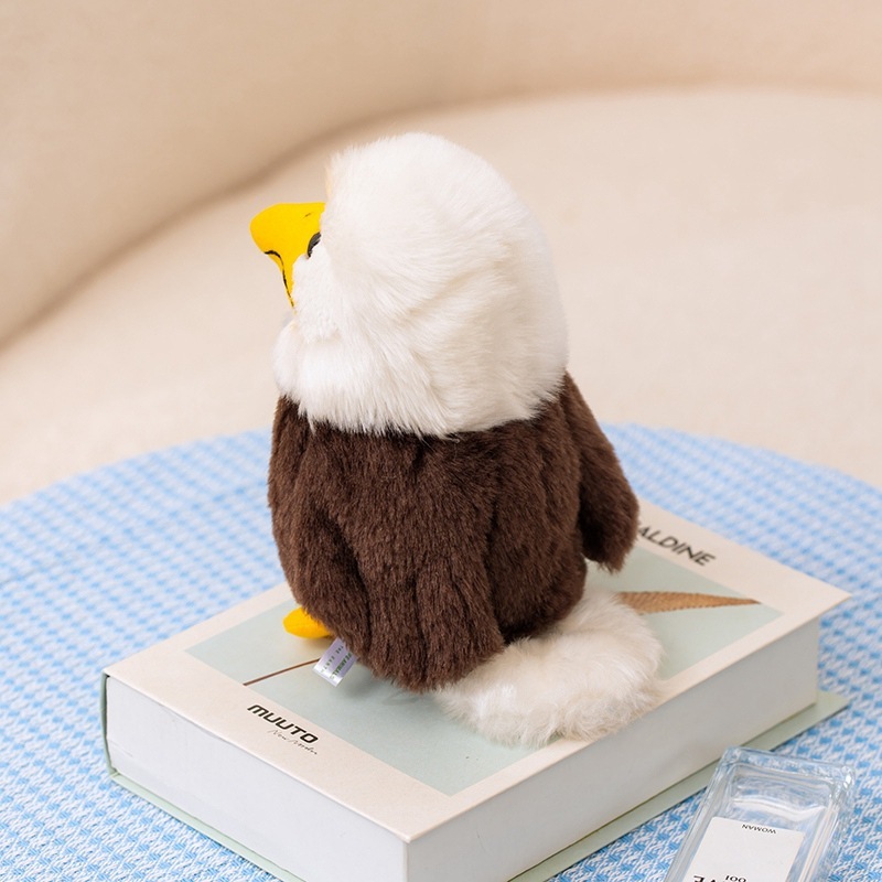 Side and back view of the Bald Eagle Plush Toy showing fluffy white feathers, brown body, soft tail details, and compact display-friendly design