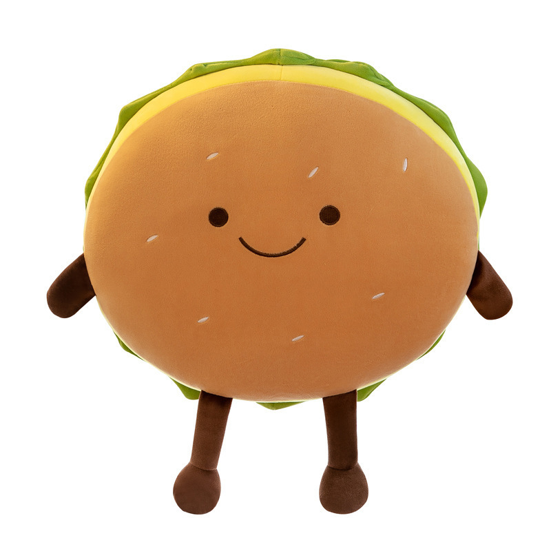 Cute burger plush pillow with a smiling face, soft plush fabric, rounded cushion design, and adorable dangling arms and legs on a clean white background