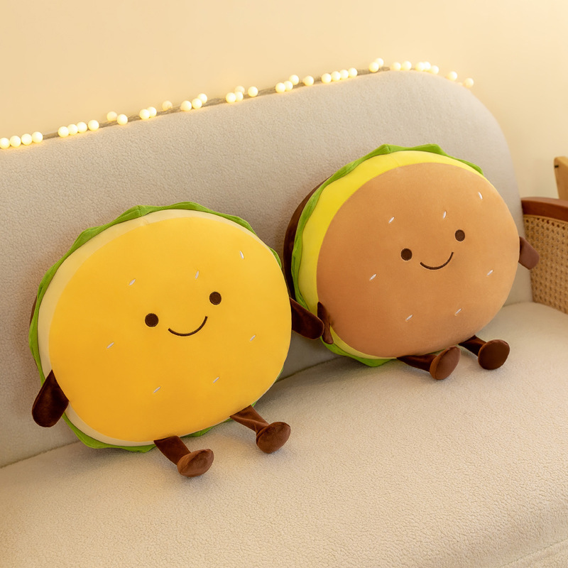 Cute burger plush pillows resting on a sofa, adding a soft, cheerful, and cozy touch to bedrooms, living rooms, and relaxing spaces