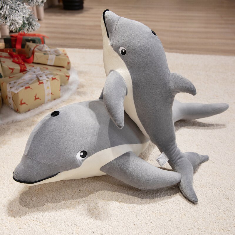 Cute Dolphin Plush Pillows displayed together to showcase their soft design and different sizes