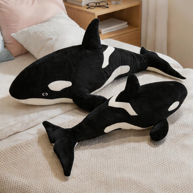Orca Killer Whale plush pillows displayed on a bed, offering soft comfort for hugging, sleeping, and cozy bedroom decor
