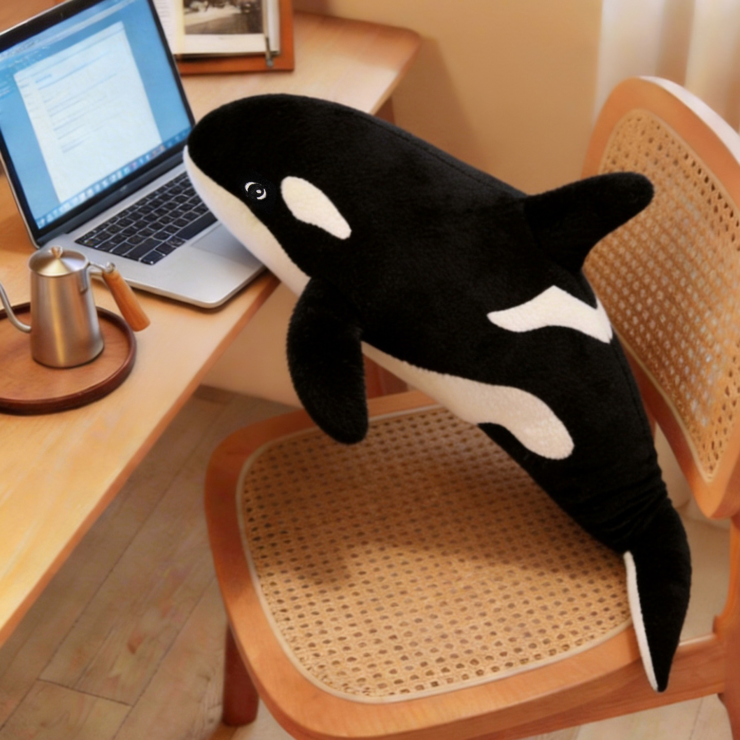 Orca Killer Whale plush pillow displayed beside a workspace, adding soft comfort and cozy ocean-themed decor to a home office