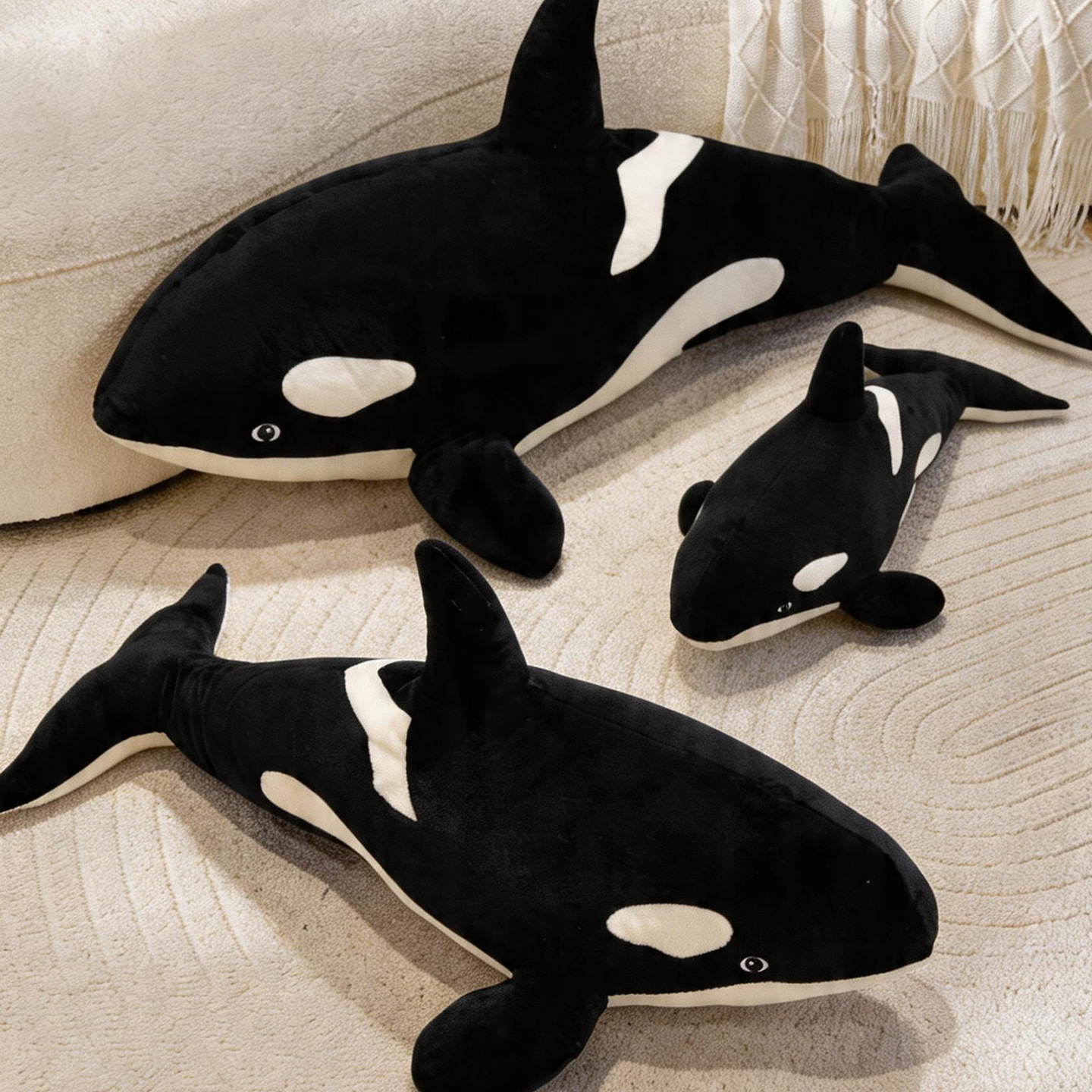 Orca Killer Whale plush pillows in multiple sizes displayed on a sofa, ideal for cuddling, decorating, and cozy ocean-themed spaces
