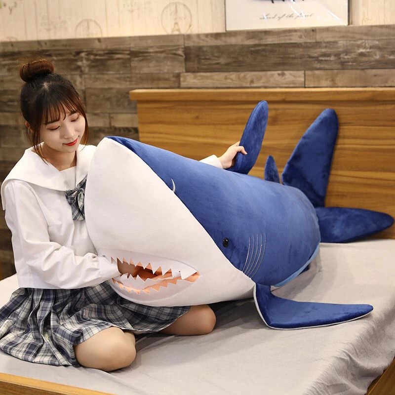 Megalodon Shark Plush Toy on a bed, featuring a soft plush body for hugging and cozy comfort