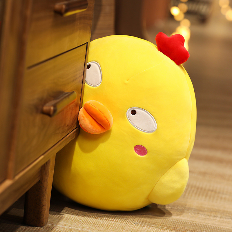 Funny Yellow Chick Plush Toy with Side Eyes expression peeking beside a wooden cabinet