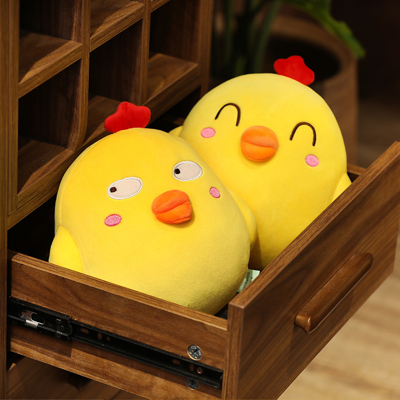 Funny Yellow Chick Plush Toy with Happy Eyes and Side Eyes designs tucked inside a wooden drawer