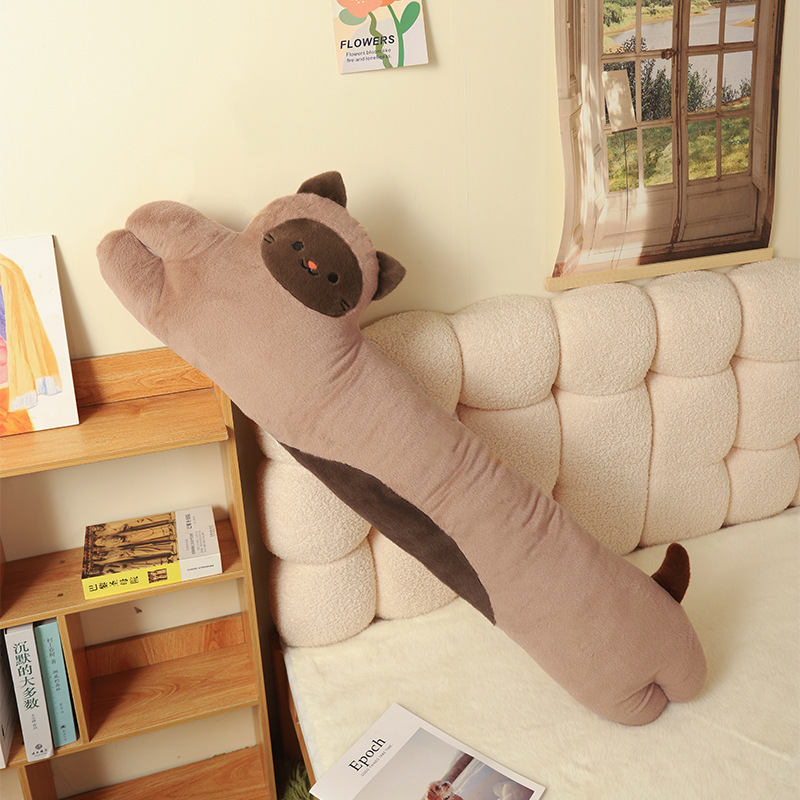 Siamese Cat Long Plush Pillow leaning against a bed, featuring a soft elongated body for hugging, lounging, sleeping, and bedroom decoration