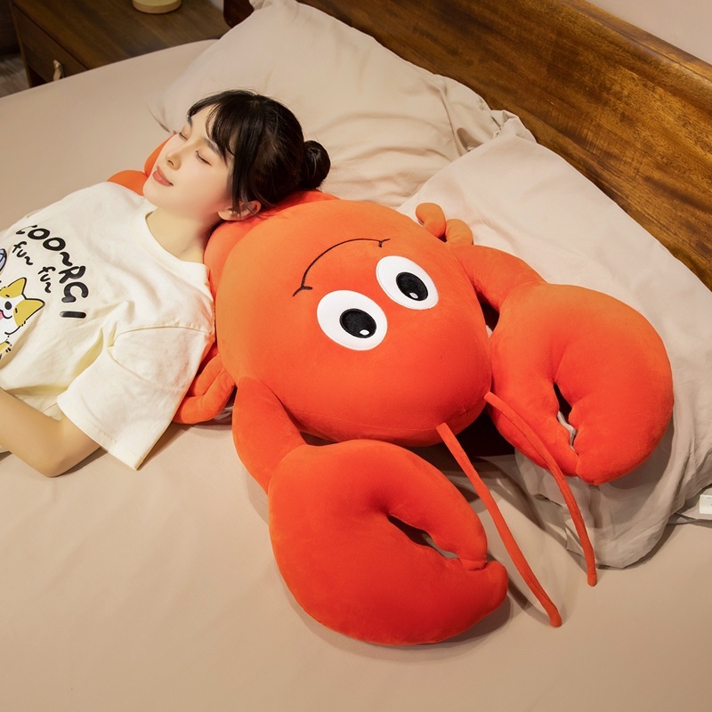Cute Lobster Plush Pillow used as a soft pillow for resting, featuring plush fabric, a cheerful embroidered face, and oversized claws for cozy comfort