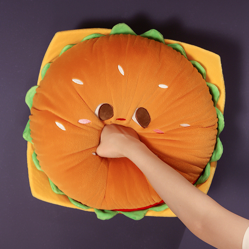 Burger Plush Pillow showing its soft, squishy plush filling with a gentle squeeze