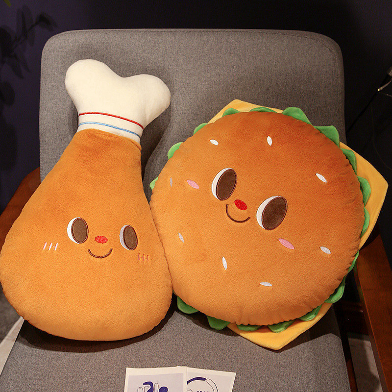 Burger and Chicken Drumstick Plush Pillows displayed together on a chair