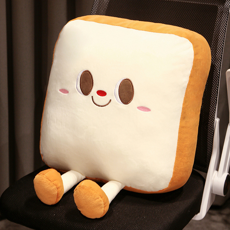 Toast Plush Pillow with a smiling bread design on a sofa