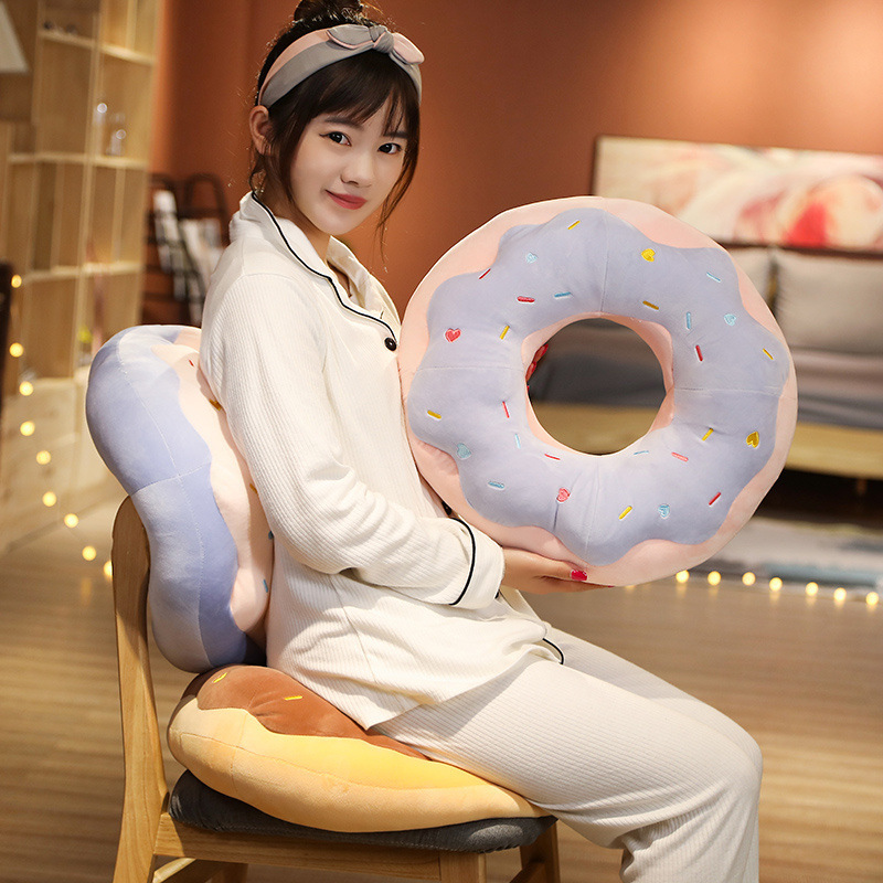 Sweet Donut Plush Pillows used as a cozy chair cushion and back support in a relaxing home setting