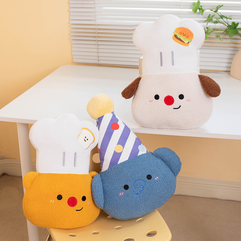 Chef Bear, Chef Dog and Party Elephant plush pillows displayed on a chair and tabletop, adding soft comfort, playful charm, and a cheerful touch to bedrooms and living spaces
