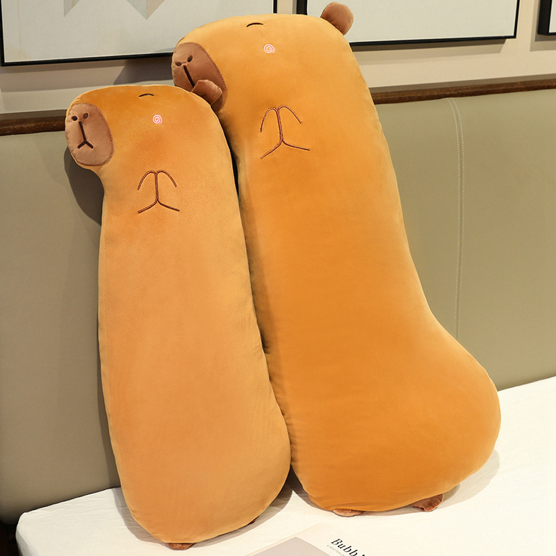 Capybara Long Plush Pillows displayed together on a bed, highlighting their soft plush fabric, long body shape, and cozy design for hugging and bedroom decor