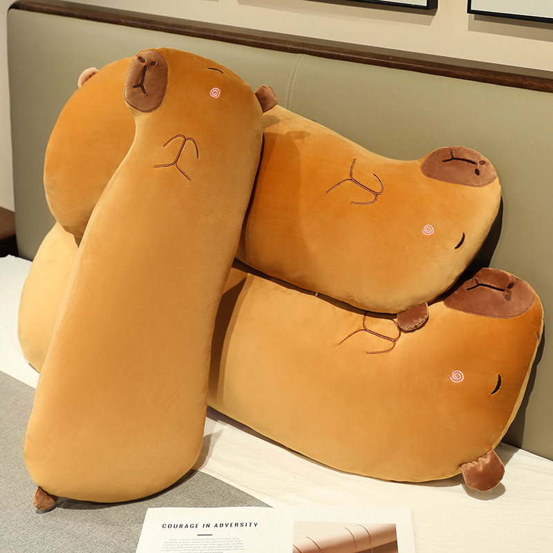 Three Capybara Long Plush Pillows displayed together on a bed, showcasing their soft plush fabric, rounded body shape, and cozy design for hugging and bedroom decor
