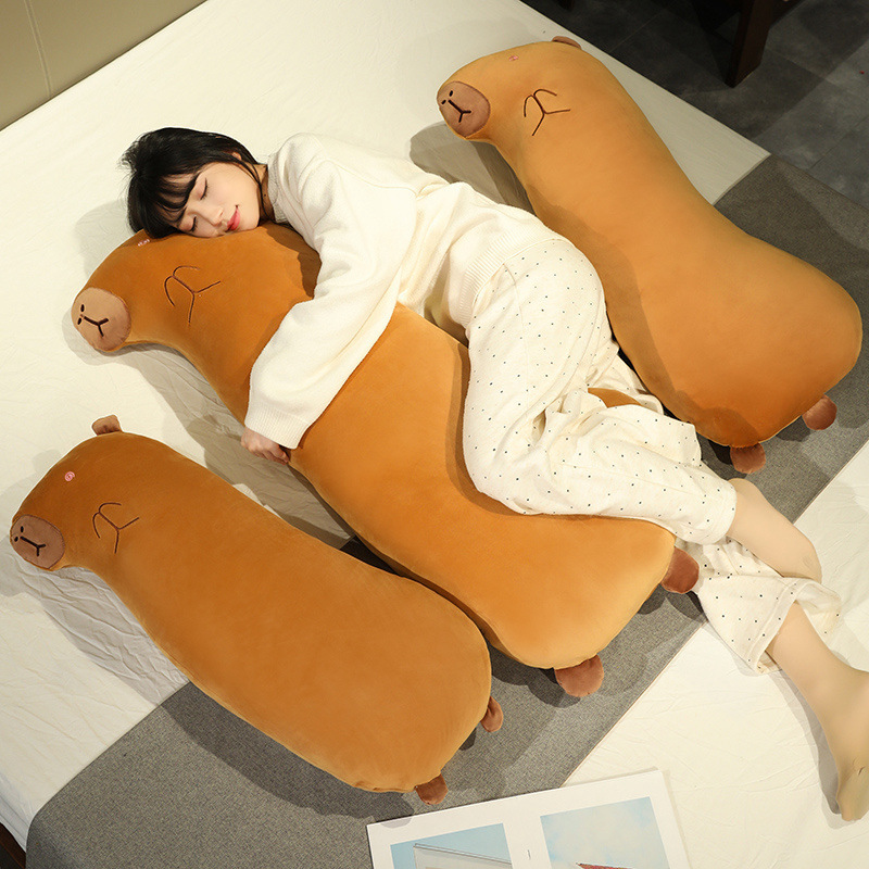 Capybara Long Plush Pillows placed on a bed, demonstrating their long body shape for hugging, sleeping, lounging, and adding a cozy touch to the bedroom