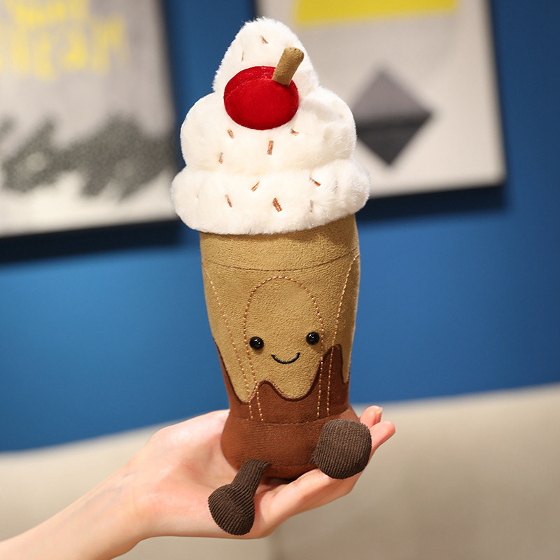 Cute Chocolate Milkshake Plush Toy with soft plush fabric, fluffy whipped cream, cherry topping, embroidered smiling face, and dangling legs