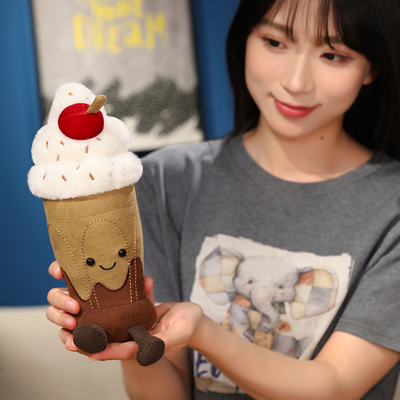 Cute Chocolate Milkshake Plush Toy with soft plush fabric, fluffy whipped cream, cherry topping, smiling face, and dangling legs