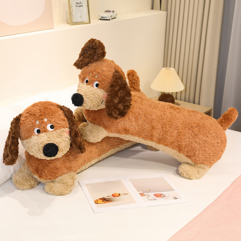 Dachshund Plush Pillows displayed on a bed, featuring long dog designs, floppy ears, soft plush fabric, and a cozy look for home decor