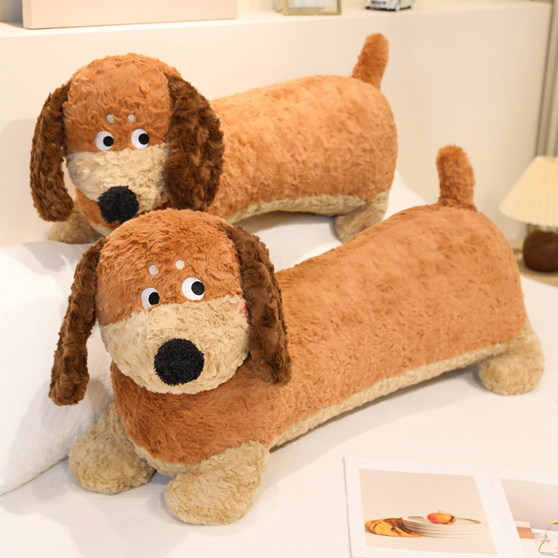 Dachshund Plush Pillow displayed on a bed, featuring a long dog design, floppy ears, soft plush fabric, and fluffy PP cotton filling for cozy home decor