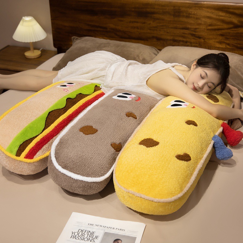 Hamburger and cookie plush pillows used for hugging, sleeping, and lounging, creating a soft and cozy bedroom atmosphere