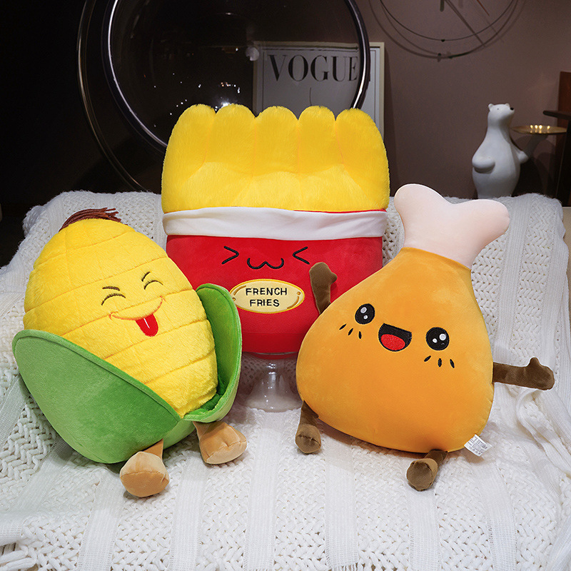 French Fries, Corn, and Chicken Drumstick Plush Pillows arranged together, featuring soft plush fabric and playful food-inspired designs