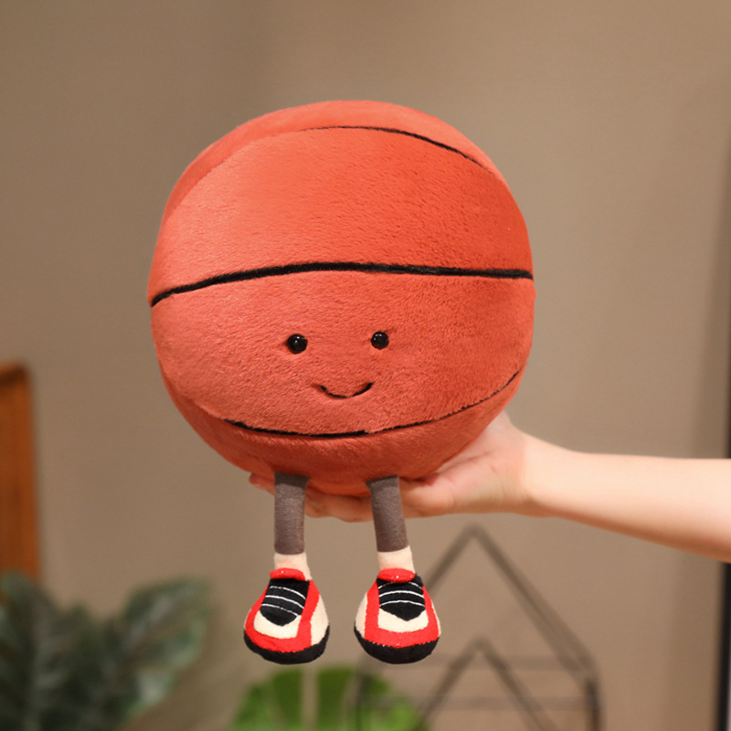 Basketball Plush Toy with a cute smiling basketball design and dangling legs, soft and cuddly for hugging, displaying, or decorating desks and shelves