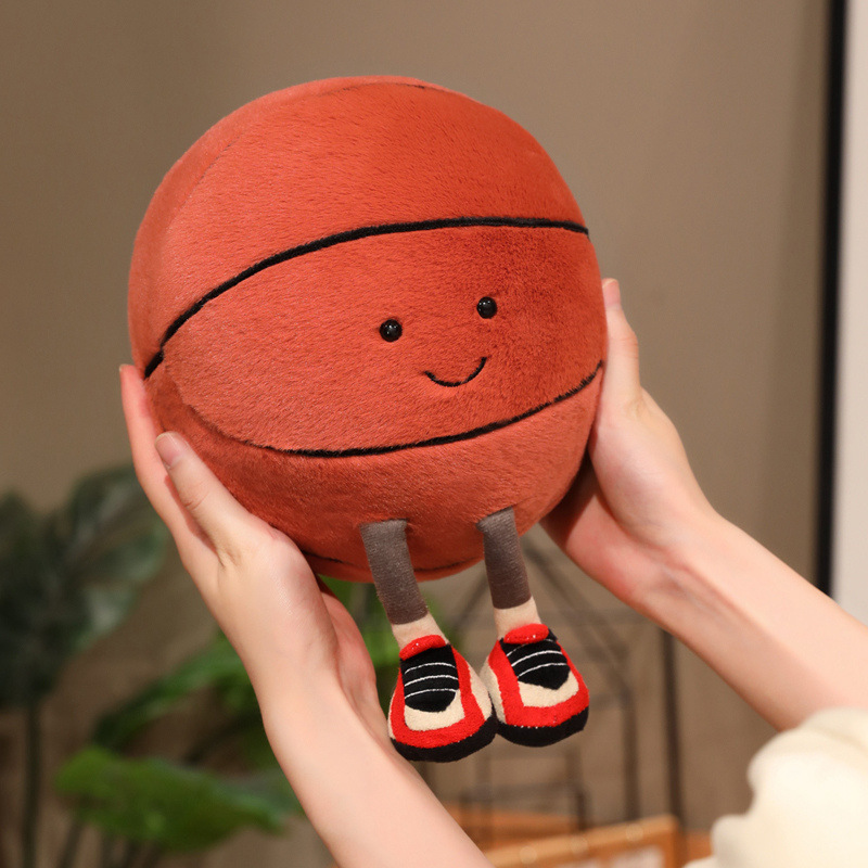 Basketball Plush Toy with a cute smiling basketball design, soft plush fabric, and adorable dangling legs for hugging, cuddling, and playful home decor