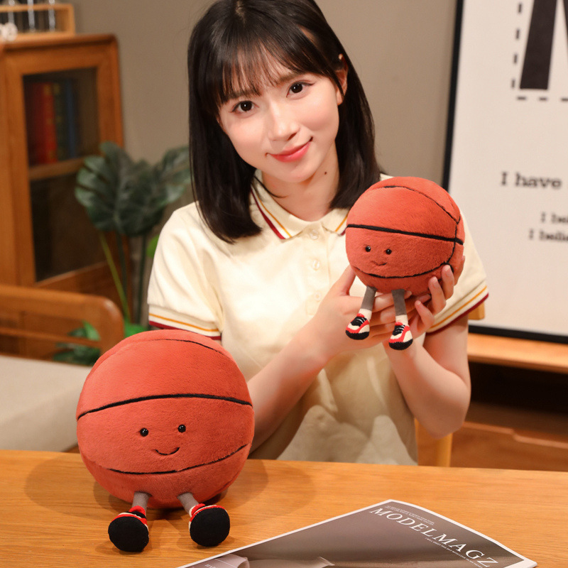 Basketball Plush Toy in multiple sizes featuring a cute smiling basketball design, perfect for displaying on tables, collecting, or adding playful charm to cozy spaces