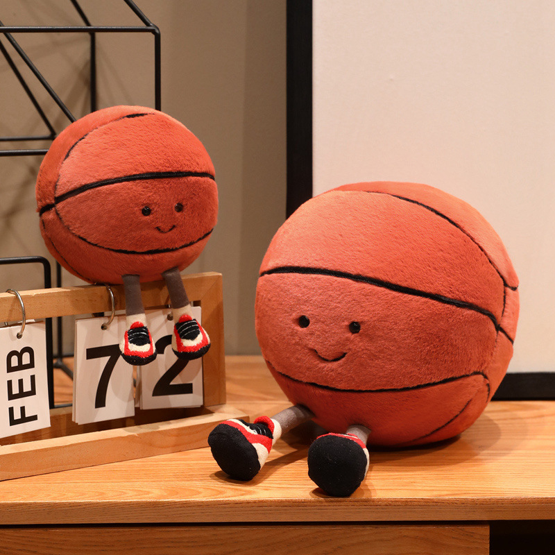 Basketball Plush Toy with a cute smiling basketball design and dangling legs, displayed on a shelf to add a playful touch to desks, bedrooms, and cozy living spaces