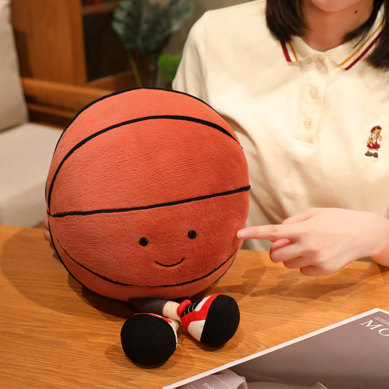 Basketball Plush Toy with a cute smiling basketball design, soft plush fabric, and adorable dangling legs, ideal for hugging, displaying, and cozy home decor