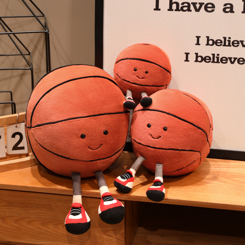 Basketball Plush Toy featuring cute smiling basketball designs with adorable dangling legs, displayed together on a table for a fun and playful decorative display