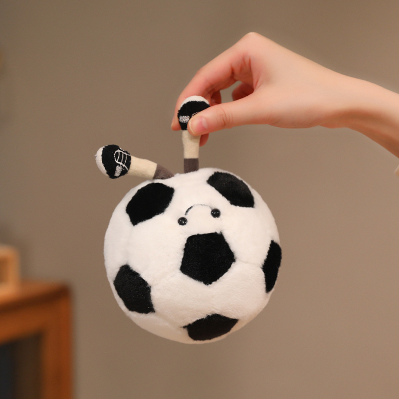 Soccer Ball Plush Toy featuring dangling legs and a cheerful smile, showcasing its fun and portable design