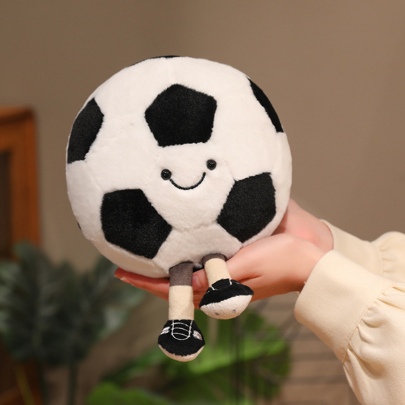 Soccer Ball Plush Toy with a cheerful smiling face and dangling legs, comfortably fitting in both hands
