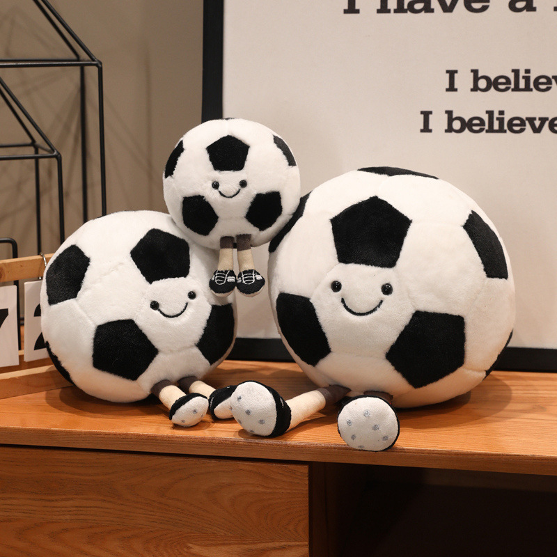 Soccer Ball Plush Toys in assorted sizes featuring soft plush fabric, cheerful smiles, and dangling legs for cozy decor