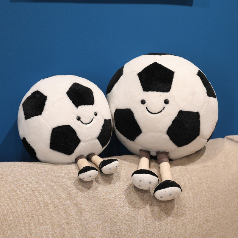 Soccer Ball Plush Toys with smiling faces and dangling legs displayed together on a sofa for cozy home decor