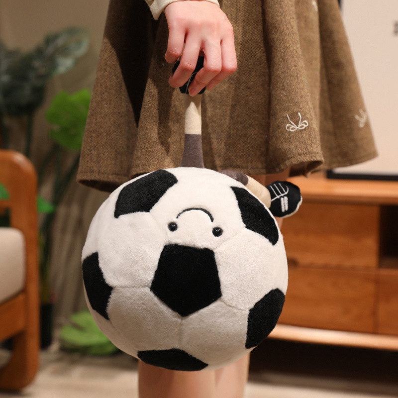 Soccer Ball Plush Toy with smiling face and dangling legs, showcasing its playful design and soft plush fabric