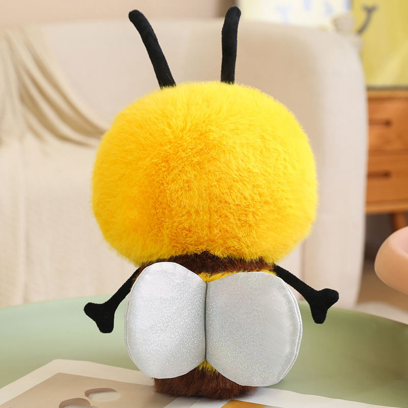Back view of the Bee Plush Toy showing its soft plush fabric, fluffy striped body, silver wings, and bumblebee design details