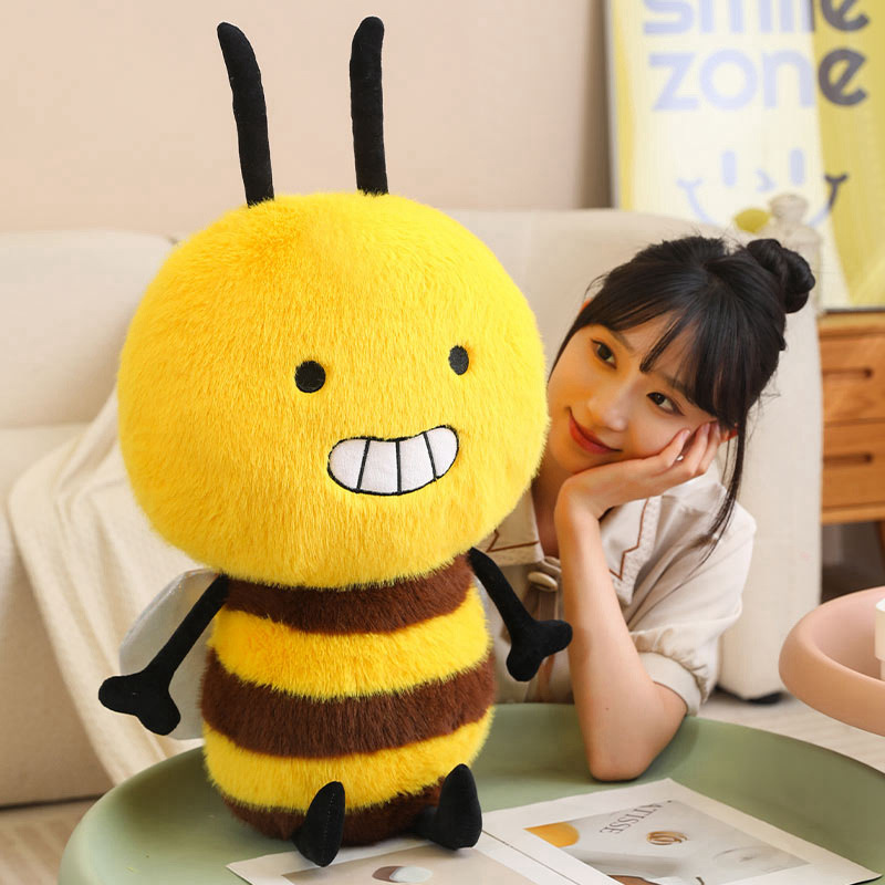 Bee Plush Toy with a smiling bumblebee design, soft plush fabric, fluffy striped body, and tiny wings, displayed on a table for cheerful home decor