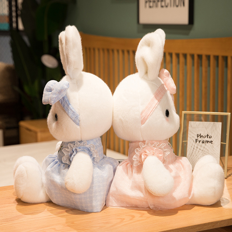 Side view of Cute Bunny Plush Toys showcasing matching bow headbands, layered daisy dresses, fluffy bunny tails, and soft plush fabric