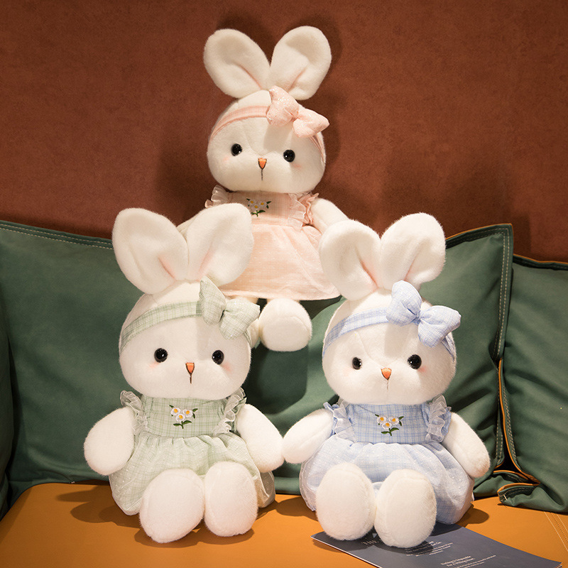 Cute Bunny Plush Toys in blue, pink, and green displayed together, showcasing the available color options with embroidered daisy dresses and matching bows