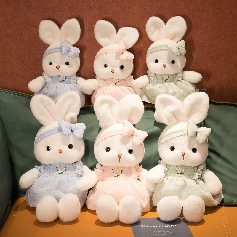 Cute Bunny Plush Toys in blue, pink, and green dresses displayed together, featuring soft plush fabric, embroidered daisy details, and matching bow headbands