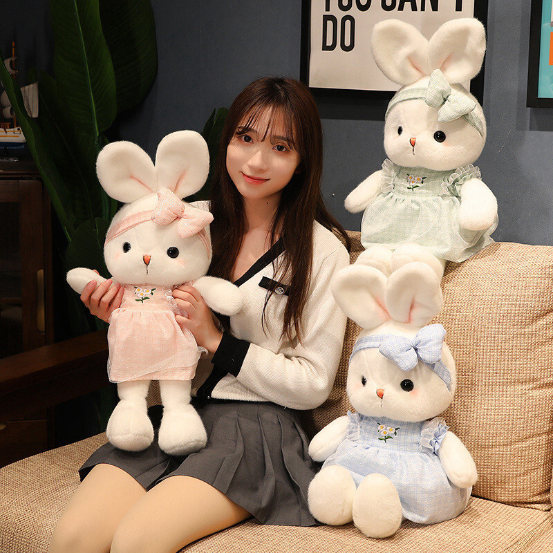 Cute Bunny Plush Toys in pink, blue, and green dresses displayed together, showcasing soft plush fabric, embroidered daisy details, and matching bow headbands