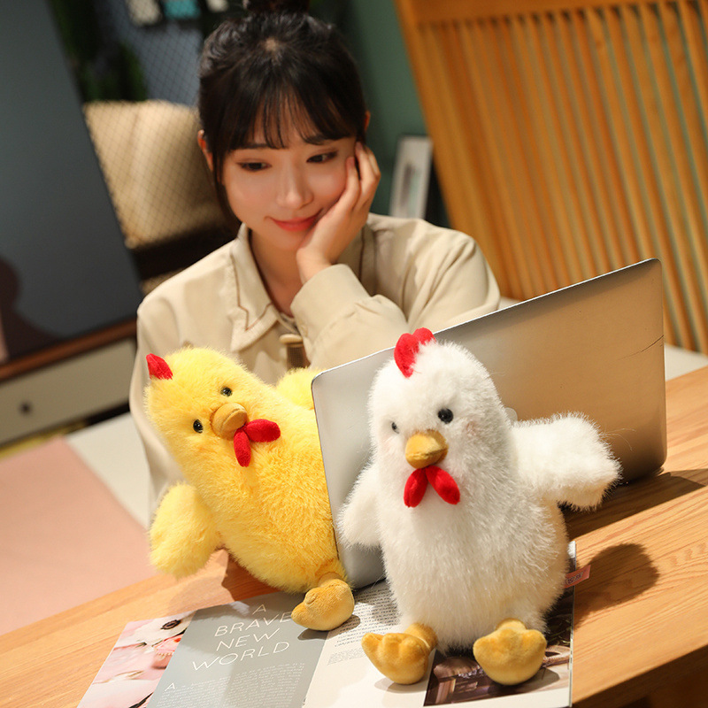Yellow and White Cute Chicken Plush Toys beside a laptop, adding soft comfort to reading, studying, or working