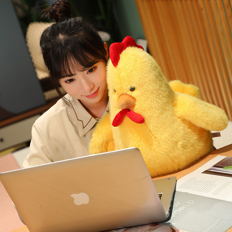 Yellow Cute Chicken Plush Toy beside a laptop, bringing soft comfort to reading, studying, or working
