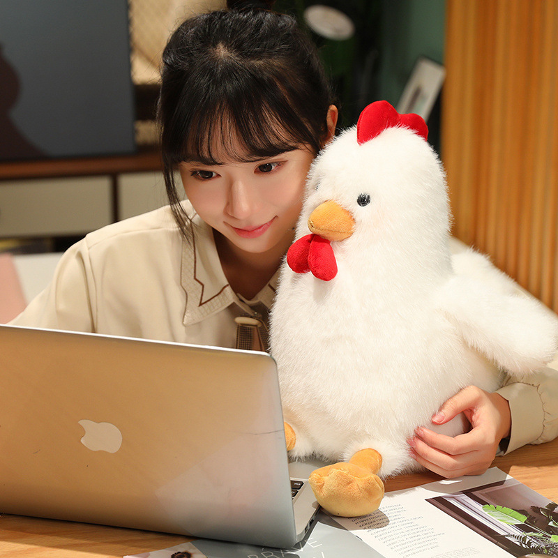 White Cute Chicken Plush Toy beside a laptop, adding warmth and comfort to reading, studying, or working